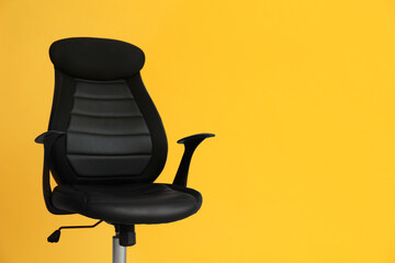 Modern office chair on yellow background. Space for text