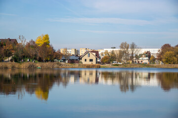 Photo of a n autumn landscape with a lake and cozy nordic houses in Vilnius