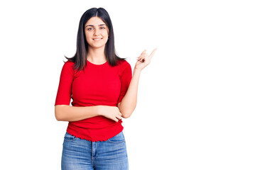 Young beautiful girl wearing casual t shirt smiling happy pointing with hand and finger to the side