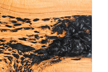 Top down view of the corner of a wood and epoxy table on a white backdrop