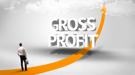 Fototapeta premium Rear view of a businessman standing in front of GROSS PROFIT inscription, successful business concept
