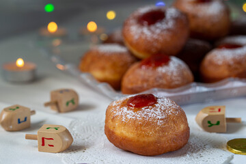 Colrful donuts over the blurred donuts over isolated white background during the Jewish holidays of Hanukkah.