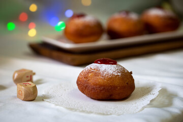 Colrful donuts over the blurred donuts over isolated white background during the Jewish holidays of Hanukkah.