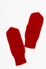 Red knitted winter mittens isolated on white background
