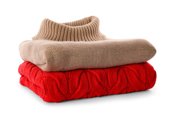 Stack of different warm sweaters isolated on white