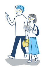 並んで街を歩く若いカップル