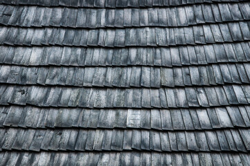 old roof made of wood. wooden background. texture with roof tiles. a lot of folded boards