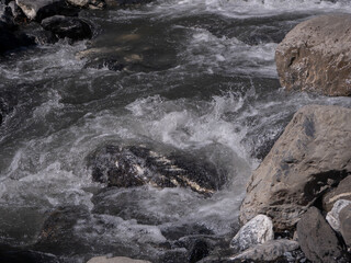 Close-up view of the stream of water flowing over rock