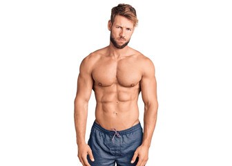 Young caucasian man standing shirtless skeptic and nervous, frowning upset because of problem. negative person.
