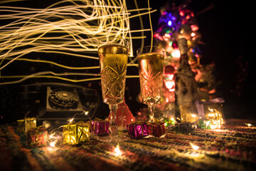 Traditional winter holiday alcohol drink in snow with creative New Year artwork. Copy space. Selective focus