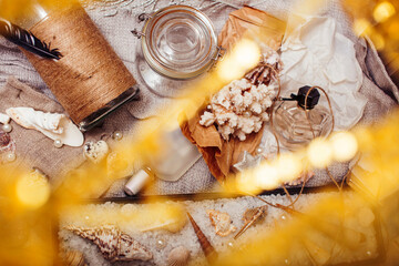a lot of sea theme in mess like shells, candles, perfume, girl stuff on linen, pretty textured post card view vintage