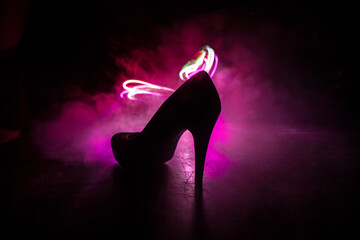 Silhouette of a high heel women shoes at dark. Women power or women domination concept.