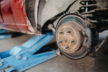 car brake disc, car on a jack - tire change.