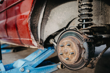 car brake disc, car on a jack - tire change.
