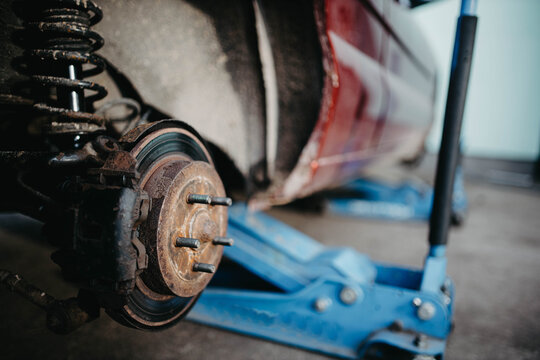 car brake disc, car on a jack - tire change.