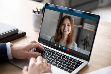 Fototapeta na wymiar Close up young businessman talk speak discuss project by online video call with female colleague, hr manager holding distant job interview with remote worker vacancy applicant, communication concept.
