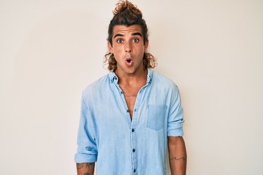 Young hispanic man wearing summer style scared and amazed with open mouth for surprise, disbelief face