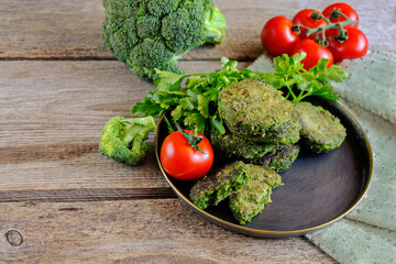 Fried vegetarian patties on a plate with the tomatoes. Healthy vegetarian or vegan food. On a wooden table.