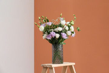 Bouquet of beautiful Eustoma flowers on wooden stand