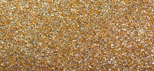 Detailed texture of golden glitter dust surface