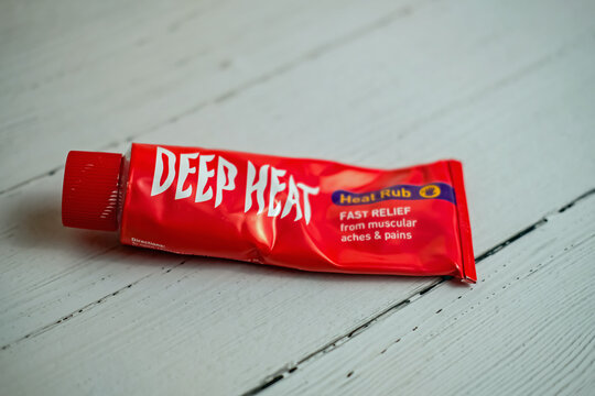 Norwich, Norfolk, UK &ndash; November 14 2020. Illustrative editorial photo of a tube of Deep Heat muscle ache relief cream on a white wooden top