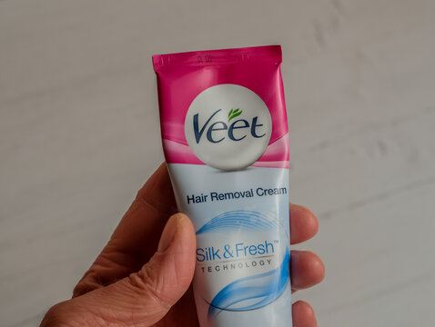 Norwich, Norfolk, UK &ndash; November 14 2020. Illustrative photo of an unidentifiable human hand holding a tube of Veet hair removal cream