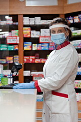Pharmacist dispensing drugs in a pharmacy. - obrazy, fototapety, plakaty