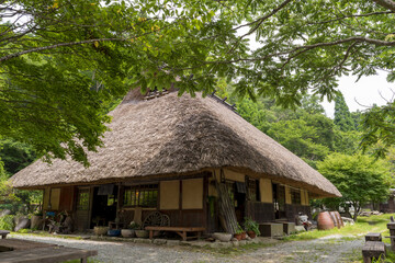 Naklejka na ściany i meble A traditional thatched roof Japanese house in Japan