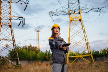 A young engineering worker inspects and controls the equipment of the power line. Energy