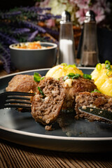 Meatballs with cheese served with boiled potatoes.