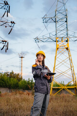 A young engineering worker inspects and controls the equipment of the power line. Energy