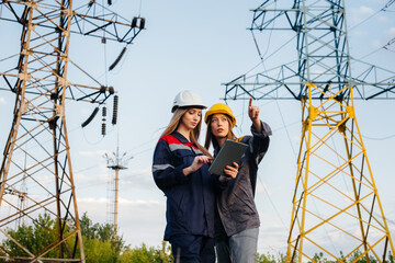 Women's collective of energy workers conducts an inspection of equipment and power lines. Energy