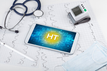 Close-up view of a tablet pc with HT abbreviation, medical concept