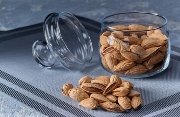 Roasted salted almonds lie on a light background.