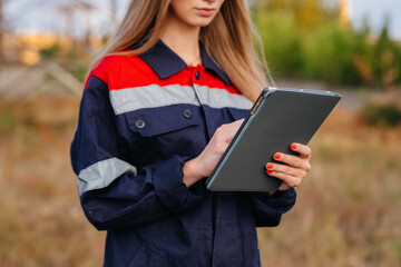 A young engineering worker inspects and controls the equipment of the power line. Energy