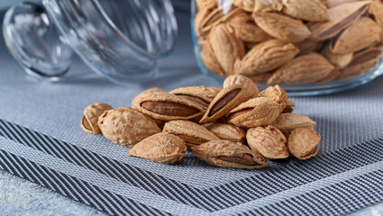Roasted salted almonds lie on a light background.