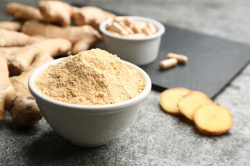 Dry, fresh and capsuled ginger on grey table. Space for text