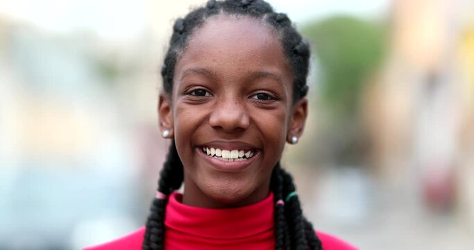 Portrait Happy teen black African girl smiling at camera