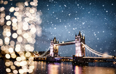 christmas lights and snow in London Tower bridge at night