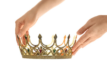 Woman holding beautiful golden crown on white background, closeup. Fantasy item