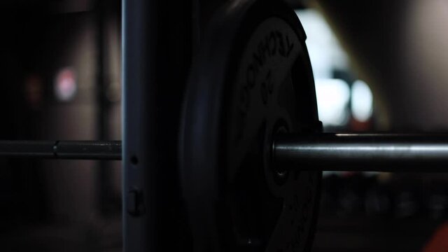 Man athlete trains with barbell in the sports gym. Fitness and workout motivation