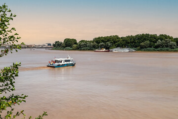Cruise boats on the river Garonne, Bordeaux, France. Brown color of the water called 