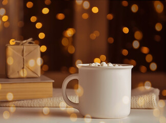 Obraz na płótnie Canvas white mug on bokeh background and gifts in blur