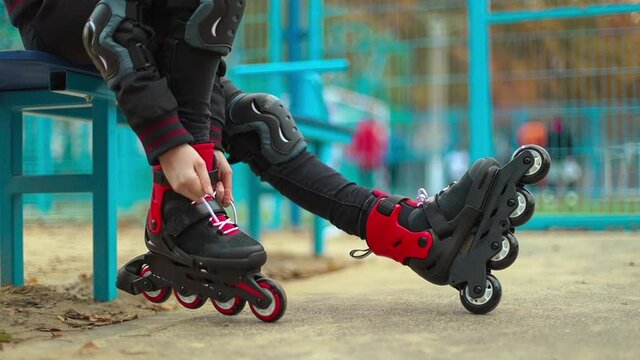 Closeup video of roller skating girl in park rollerblading on inline skates. Caucasian female kid in outdoor activities.