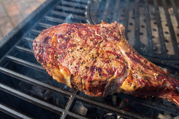 Dry Aged Barbecue Tomahawk Steak on grill