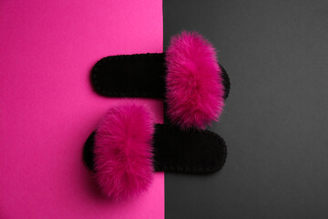 Pair of soft slippers on color background, flat lay