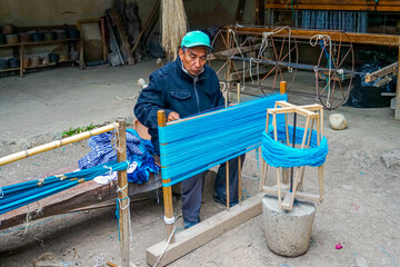 Ecuador, A man is weaving in his house in San Pedro de los Olivos. 