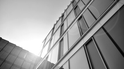 Fototapeta na wymiar Abstract modern architecture with high contrast black and white tone. Architecture of geometry at glass window - monochrome. Black and white.