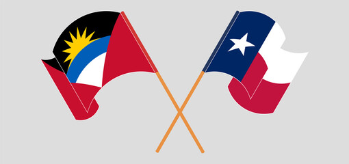 Crossed and waving flags of Antigua and Barbuda and the State of Texas