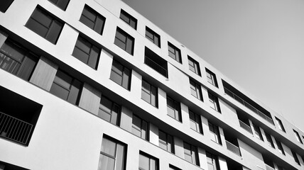 Detail of modern residential flat apartment building exterior. Fragment of new luxury house and home complex. Black and white.